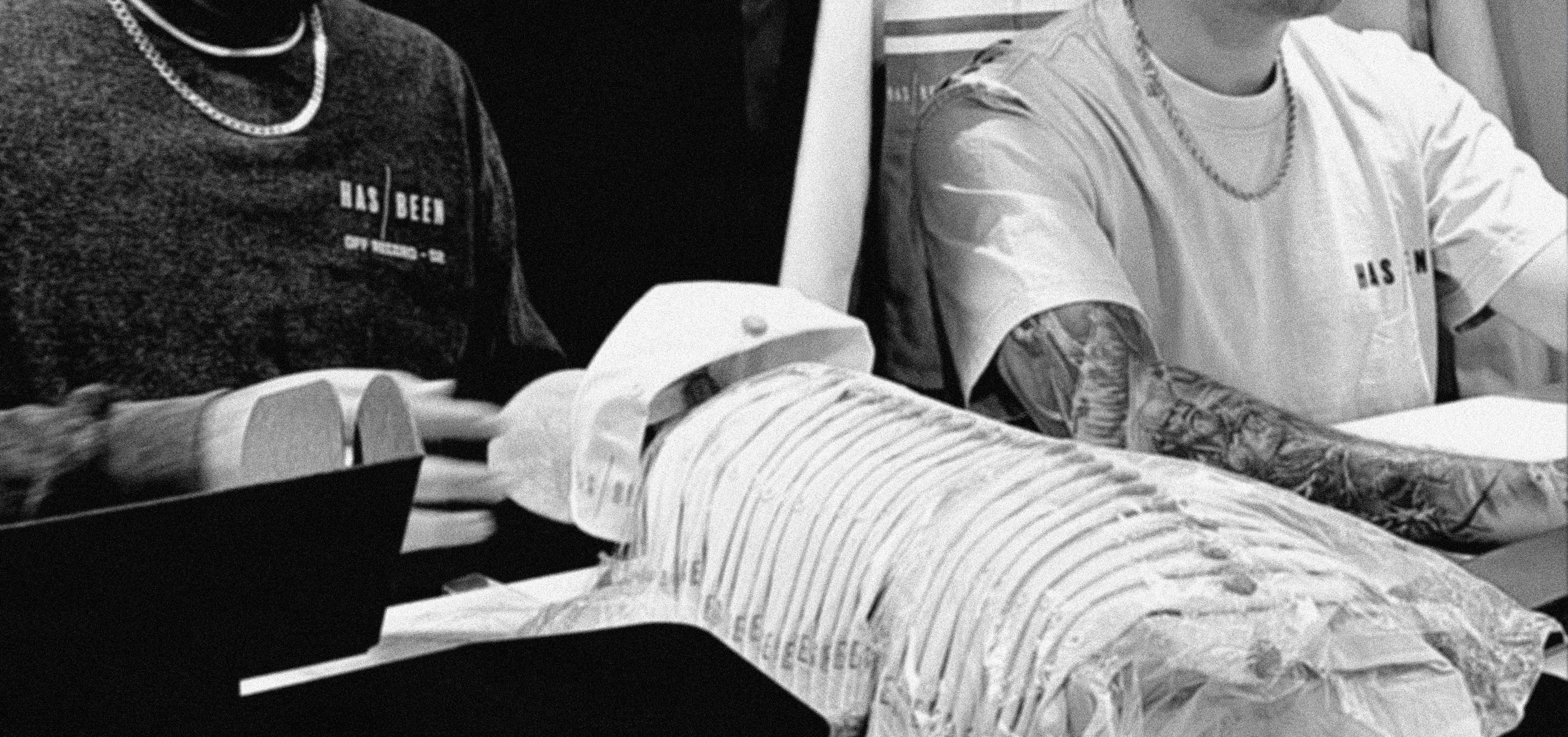 HAS/BEEN team working on clothing design process in studio
