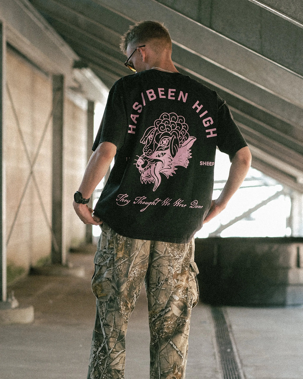 black vintage wash oversized graphic tee on model back view full body streetwear outfit