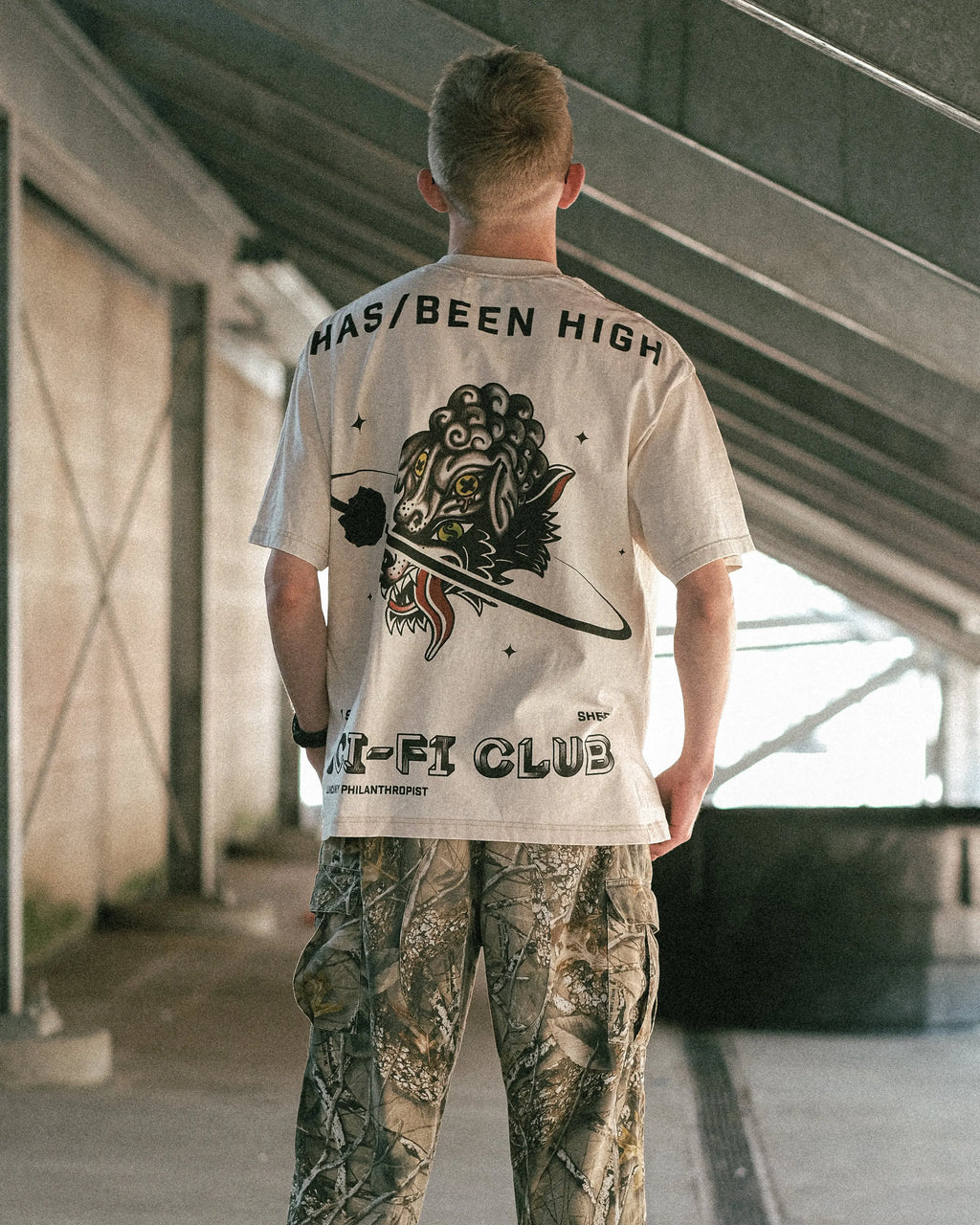 HAS/BEEN HIGH sci fi club oversized heavyweight tee beige back graphic on male model straight view