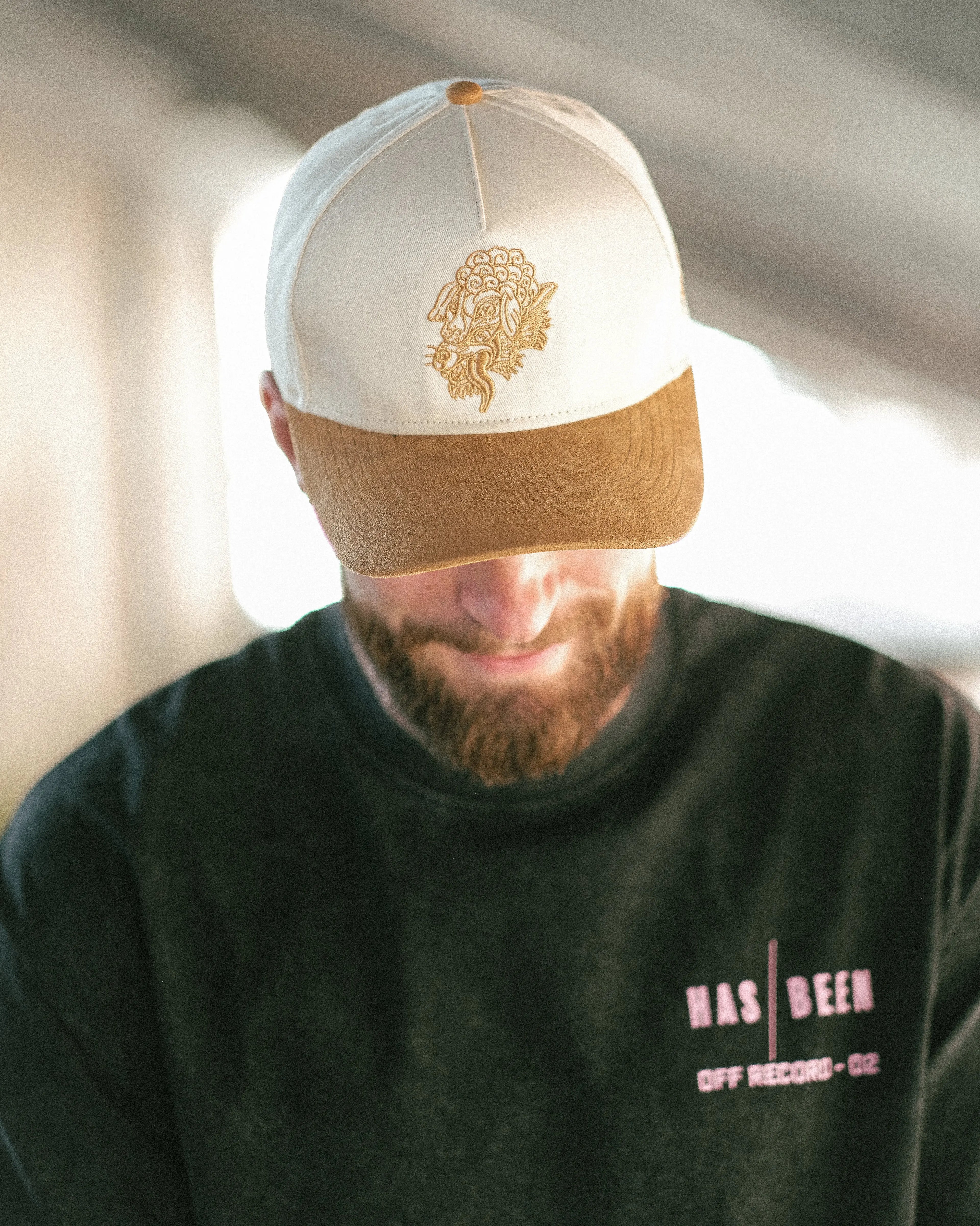 HAS/BEEN off record 5 panel cap ivory crown tan suede brim on model head down front logo detail
