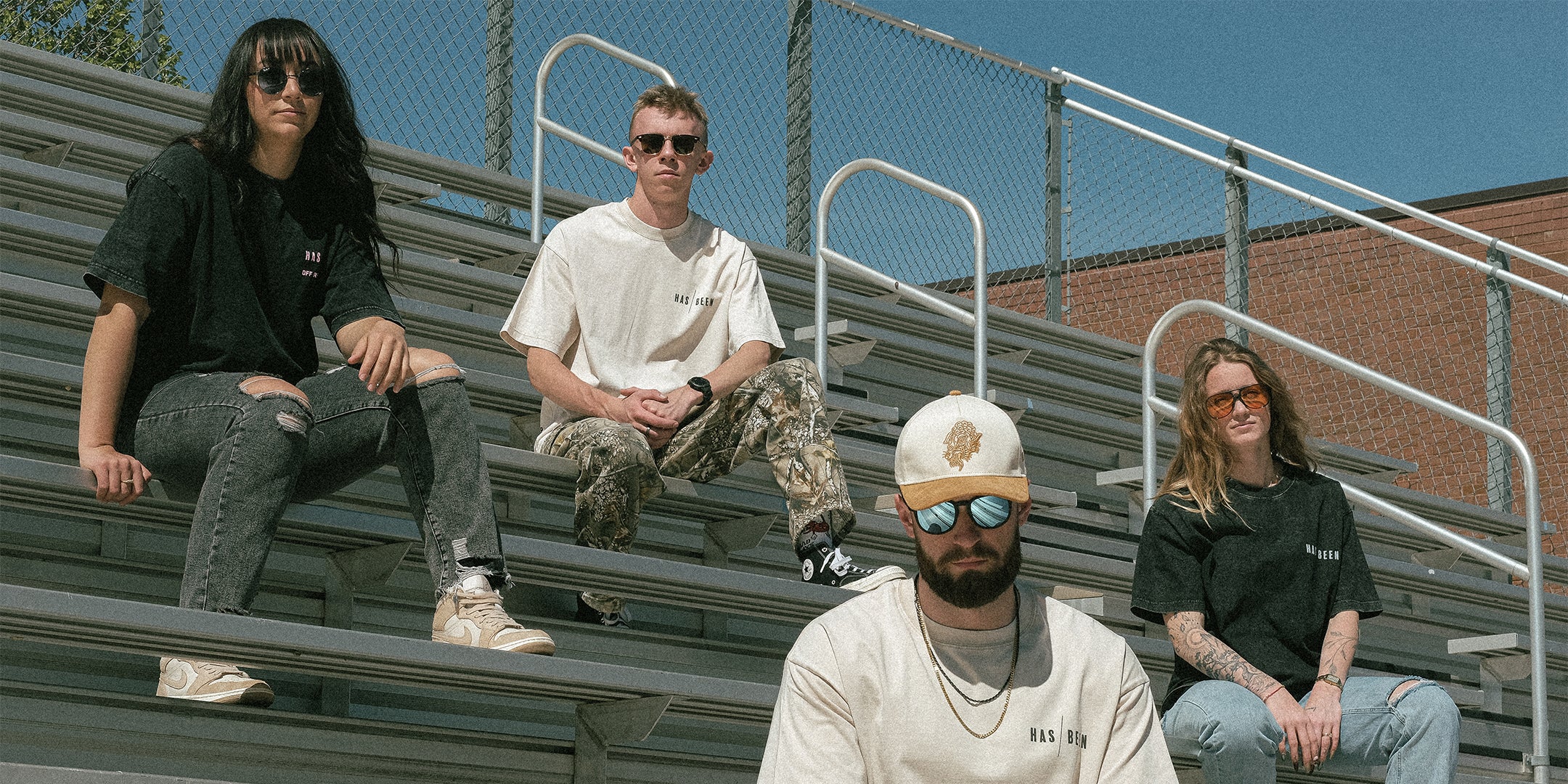 HAS/BEEN vintage streetwear brand oversized tees collection models sitting on bleachers