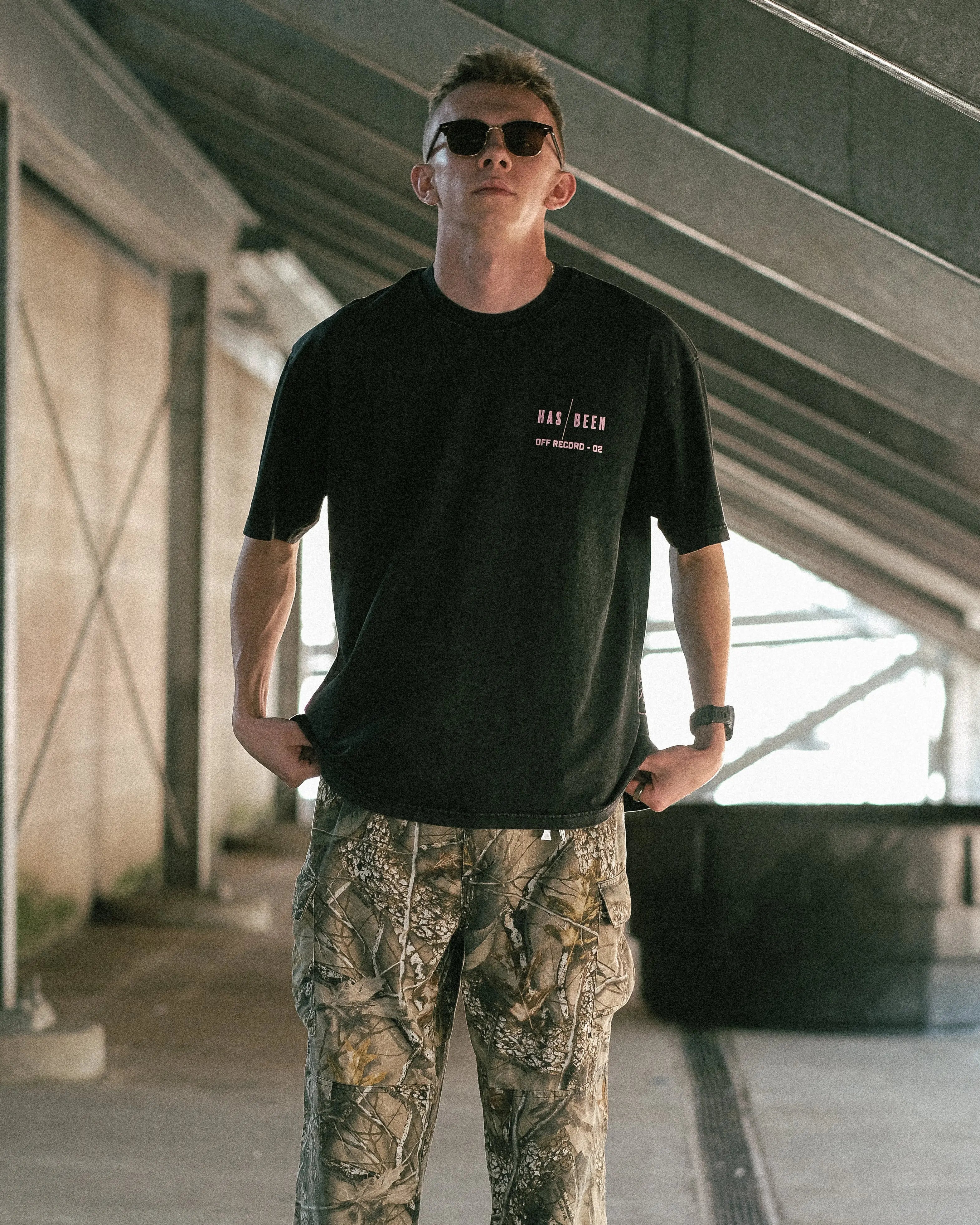 oversized black vintage wash tee from OFF THE RECORD collection on model front view full body streetwear outfit